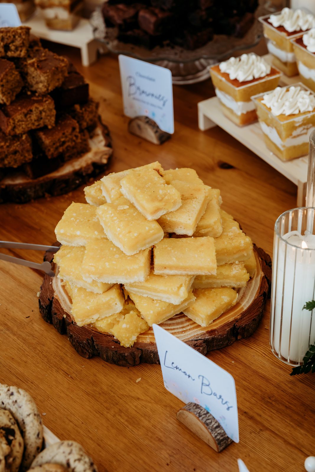 Lemon bars on a wooden slice with a label