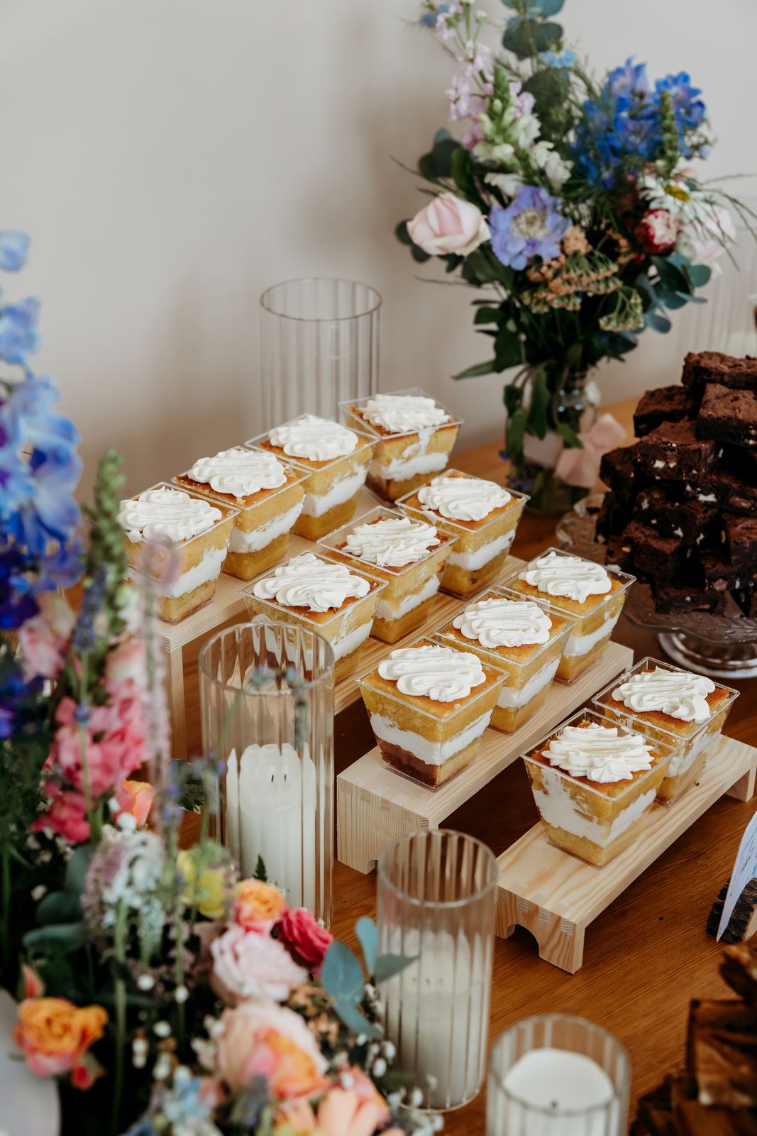 Cake pots, candles and wildflowers on our wedding dessert table