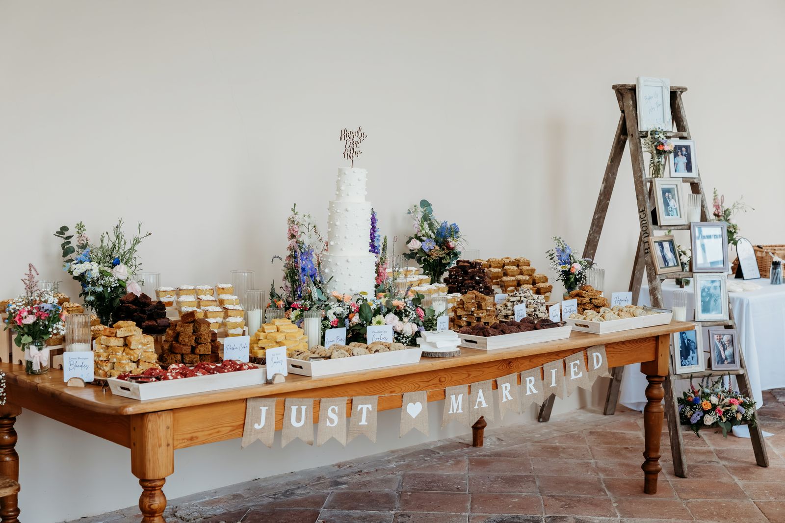A full Sugar & Slice wedding dessert table and tiered stands